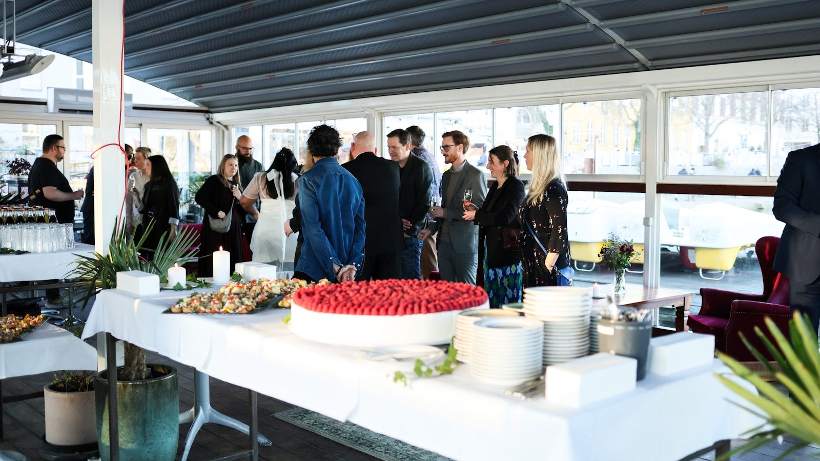People mingling around a buffet table at an event.
